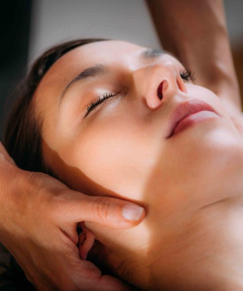 Cranial osteopathy massage. Therapist massaging woman’s head.